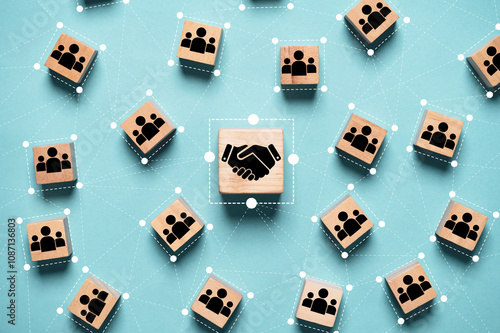 Obraz na plátne Hand shaking icon print screen on wooden block cube and linkage with people icon for corporate and business deal agreement concept