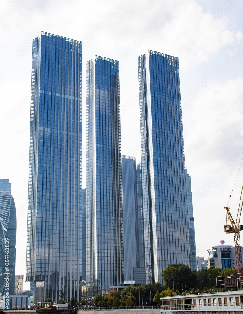 Tall skyscrapers look very impressive towering over the city against the sky. Tall skyscrapers look very impressive towering over the city against the sky.