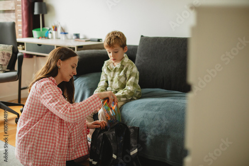 Canvastavla Mother helping her son get ready for school