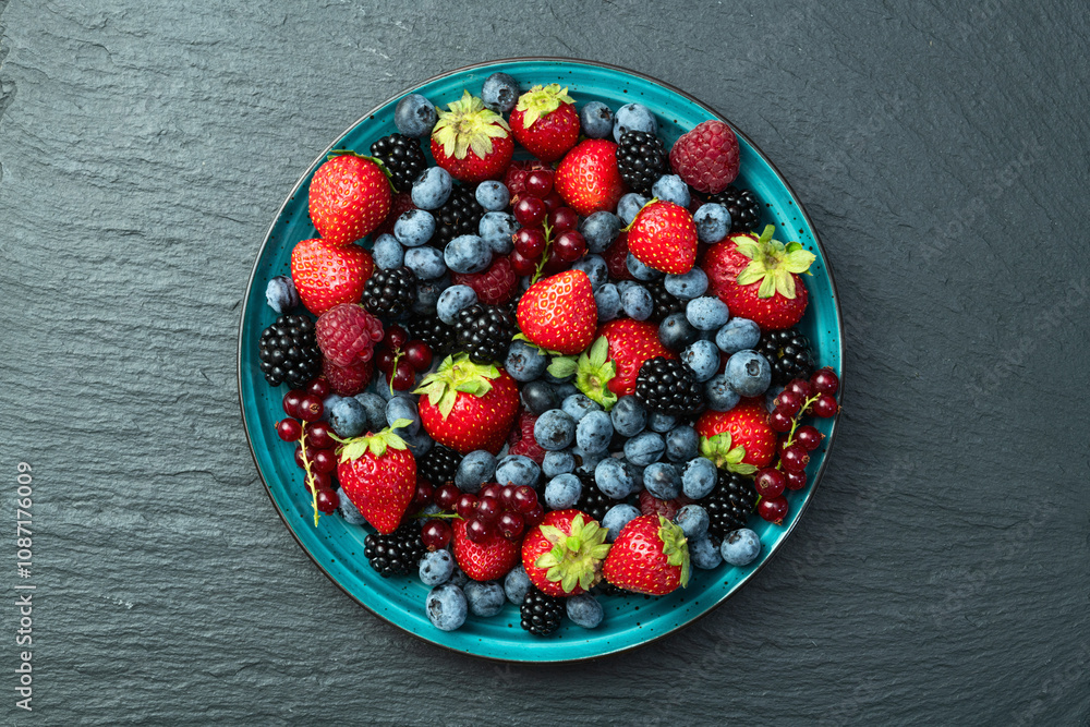 Mix of ripe colorful berries in bowl photography . Blueberry , strawberry , raspberry , blackberry and red currant . Top view Mix of ripe colorful berries in bowl photography . Blueberry , strawberry , raspberry , blackberry and red currant . Top view