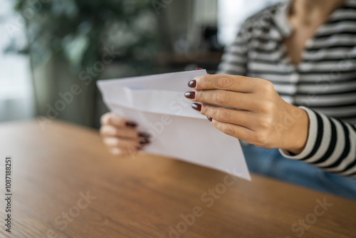 close up of woman hand receive letter, invitation or notification photo