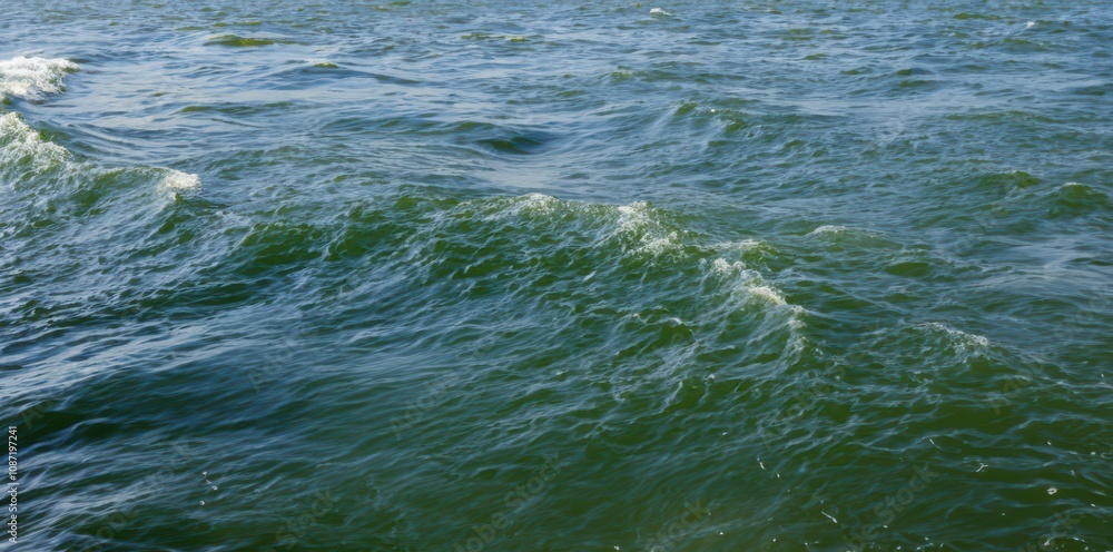Ocean waves: dynamic movement of blue-green water with sunlight reflections Ocean waves: dynamic movement of blue-green water with sunlight reflections