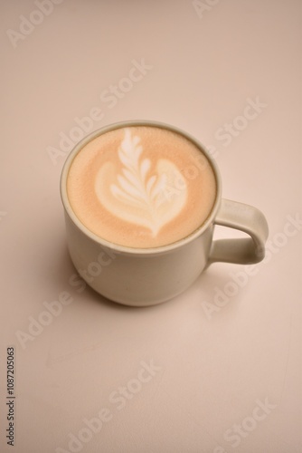 Freshly brewed cappuccino with delicate milk foam art, served on a bright table — a calm and cozy coffee moment.