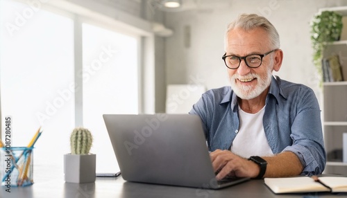 Senior Executive Working on Laptop: A seasoned business professional, radiating confidence and experience, diligently works on his laptop in a modern office setting. The image exudes a sense of focus.