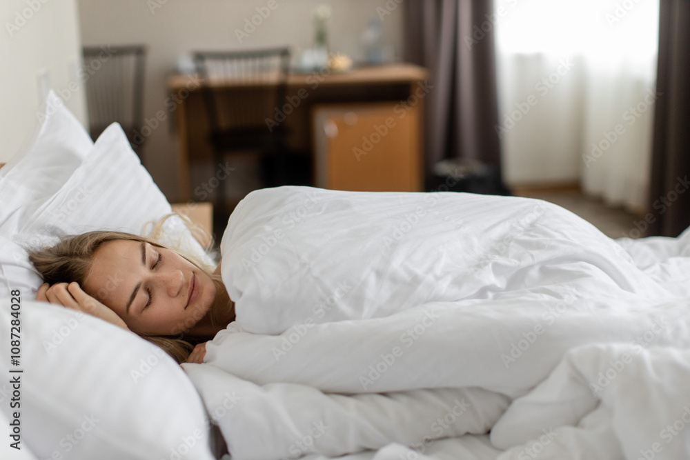 Peaceful woman resting in bed during the morning Peaceful woman resting in bed during the morning