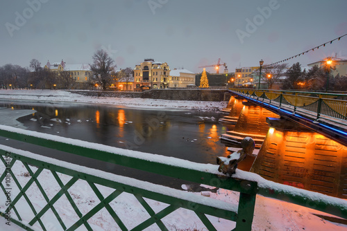 uzhhorod, ukraine - dec 26, 2016: christmas tree on the central square. magic scenery with frozen river.