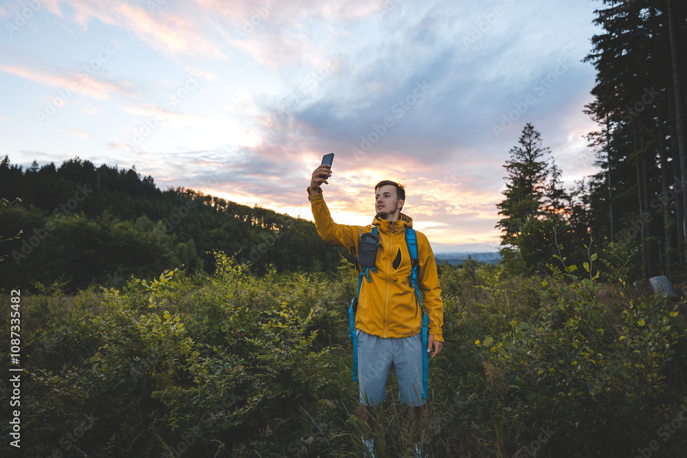 Hiker in a yellow jacket taking a selfie at sunset in the Beskydy Mountains, Czech Republic. Embracing adventure and capturing the moment in nature’s colorful backdrop Hiker in a yellow jacket taking a selfie at sunset in the Beskydy Mountains, Czech Republic. Embracing adventure and capturing the moment in nature’s colorful backdrop