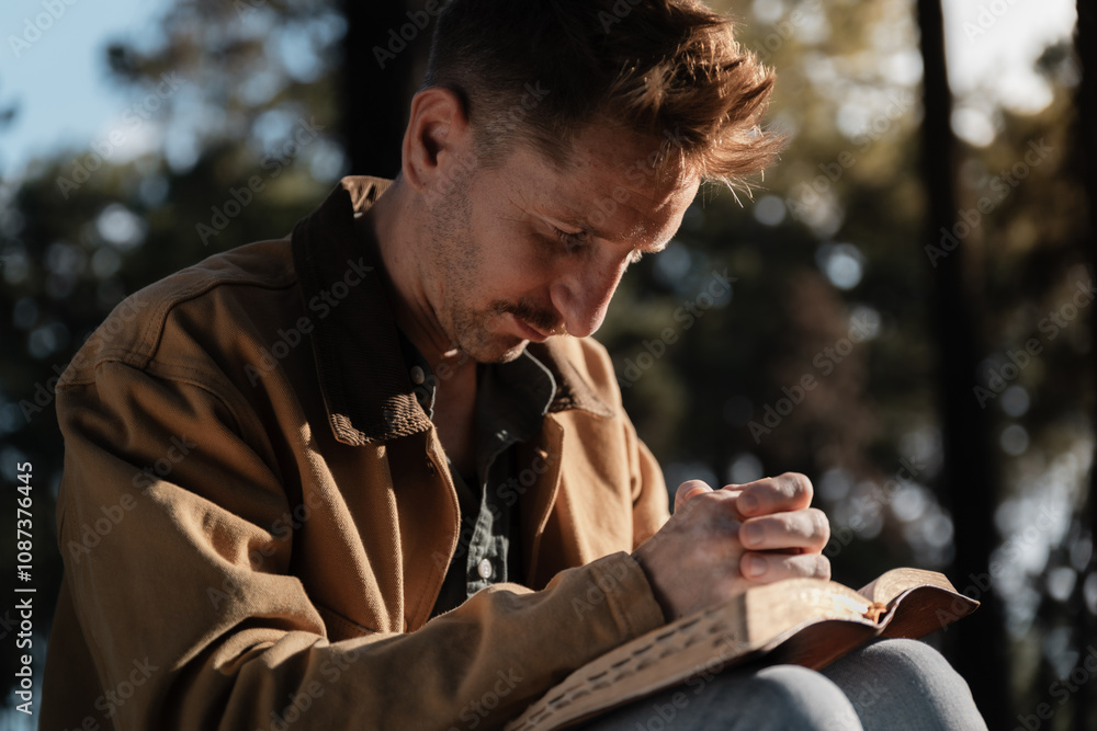 Christian read and pray with holy bible in forest with Holy light shining. Pray to God to confess your sins and ask for blessings to overcome his problems. faith, and religion. Christian read and pray with holy bible in forest with Holy light shining. Pray to God to confess your sins and ask for blessings to overcome his problems. faith, and religion.
