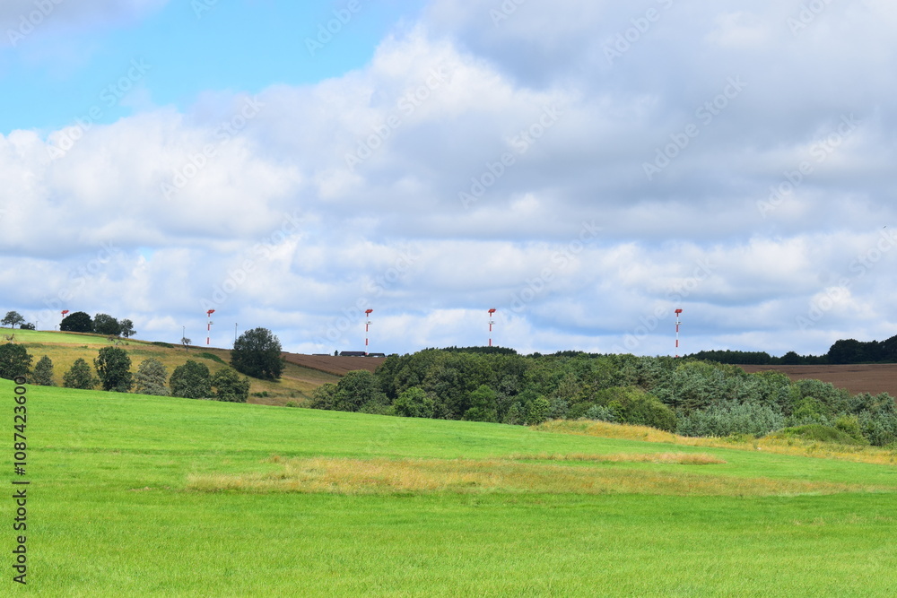 wide landscape with landing lights above the trees wide landscape with landing lights above the trees