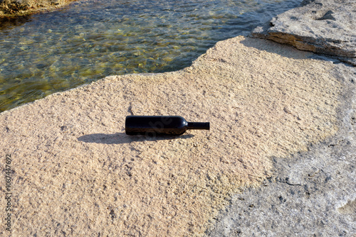 Bottle of wine on the shore.