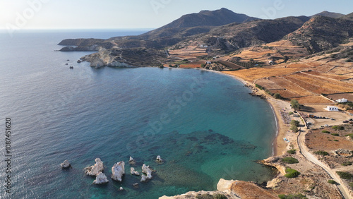 Aerial drone photo of paradise sandy organised beach of Mavrospilia with white rock formations best place to see the sunset in the island of Kimolos, Cyclades, Greece