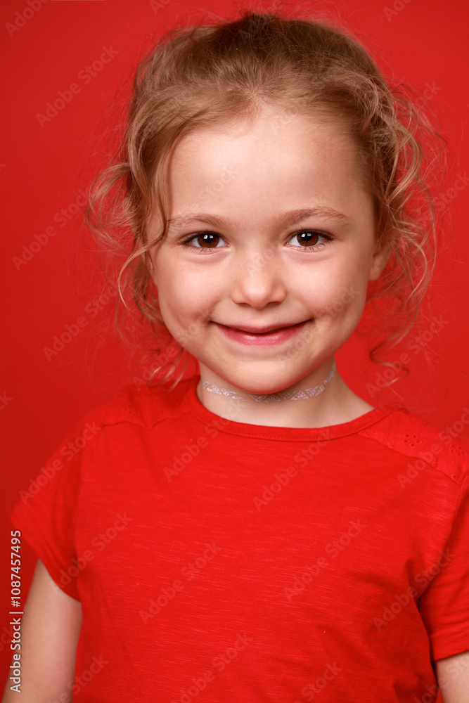Beautiful blonde little girl, isolated on red background studio Beautiful blonde little girl, isolated on red background studio