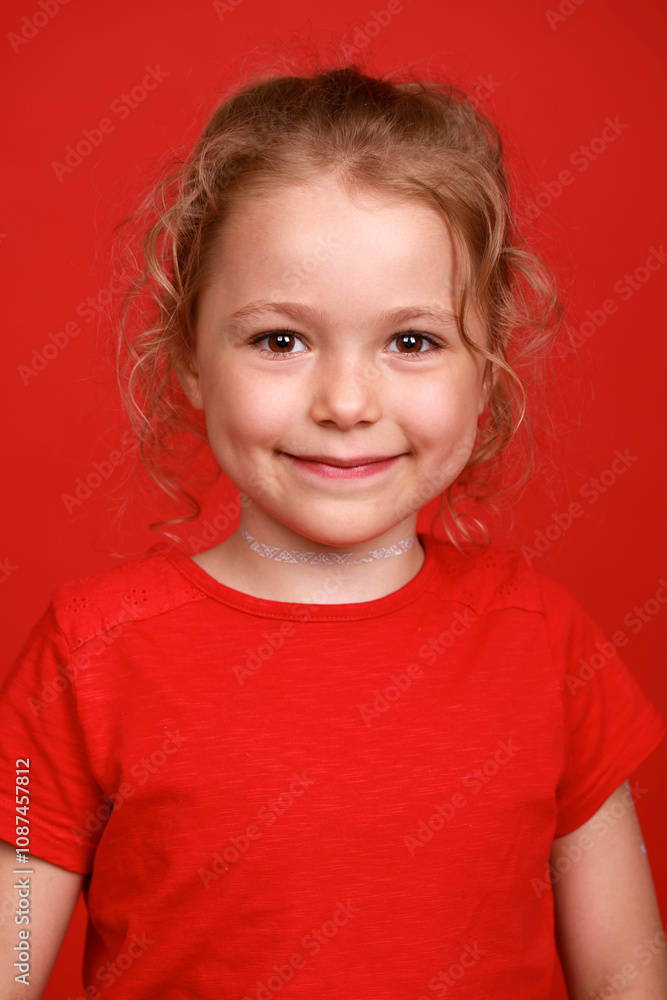 Beautiful blonde little girl, isolated on red background studio Beautiful blonde little girl, isolated on red background studio