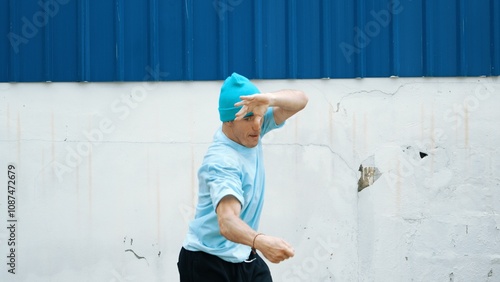 Motion shots of youthful hipster moving in lively groove at street. Caucasian break dance choreographer dancing in hip hop style. Energetic dancer perform b-boy dance. Outdoor sport 2024. Hiphop. photo