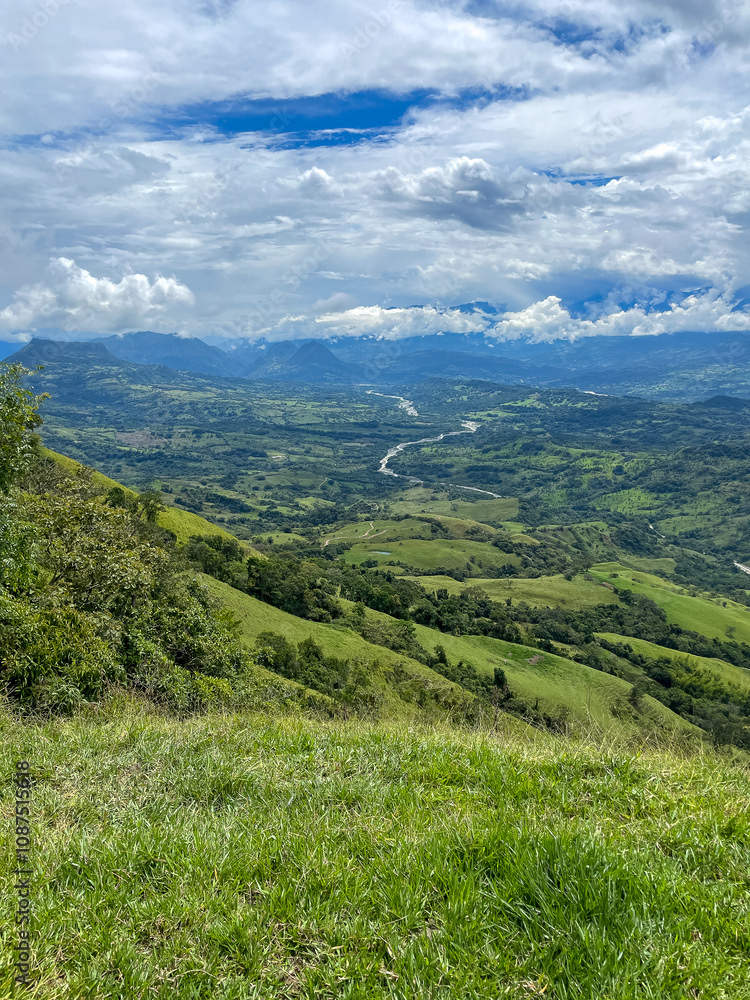 Beautiful natural landscape of the Poblanco river in southwestern Antioquia, Colombia with mountains in the background aerial view. Beautiful natural landscape of the Poblanco river in southwestern Antioquia, Colombia with mountains in the background aerial view.