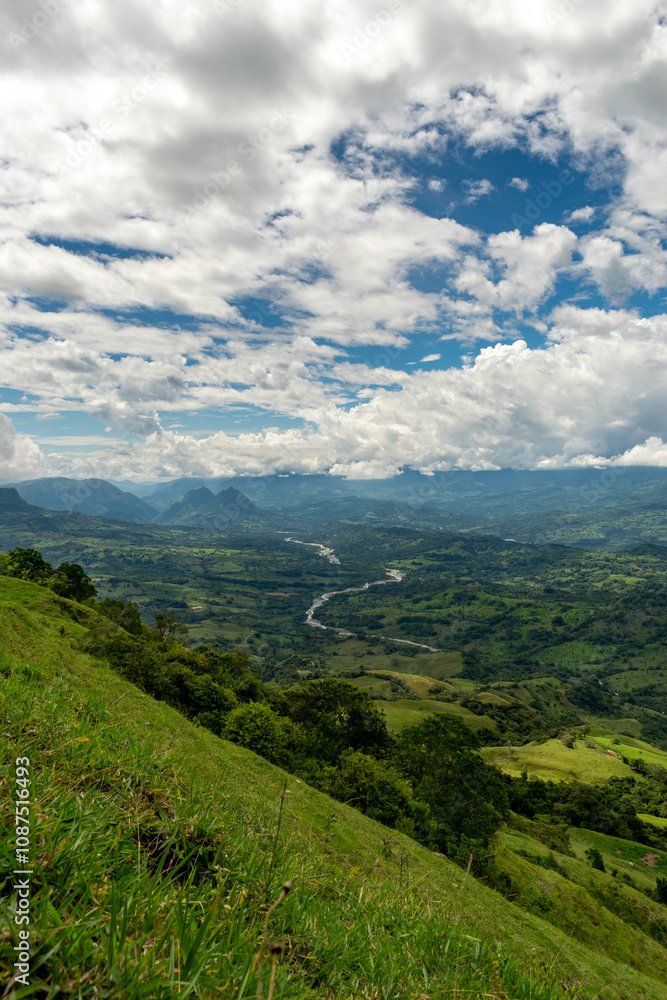 Beautiful natural landscape of the Poblanco river in southwestern Antioquia, Colombia with mountains in the background aerial view. Beautiful natural landscape of the Poblanco river in southwestern Antioquia, Colombia with mountains in the background aerial view.