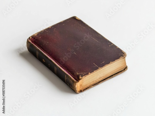 A vintage, worn book with a maroon cover, suggesting age and historical significance.