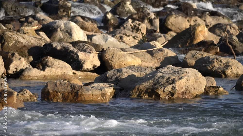 A rocky shoreline with gentle waves creates a serene environment, showcasing natures beauty A rocky shoreline with gentle waves creates a serene environment, showcasing natures beauty