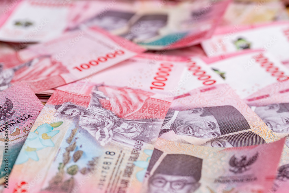Indonesia money, stack of 100000 thousand Indonesian rupiah banknotes. New paper banknotes, Business concept. Financial background Indonesia money, stack of 100000 thousand Indonesian rupiah banknotes. New paper banknotes, Business concept. Financial background