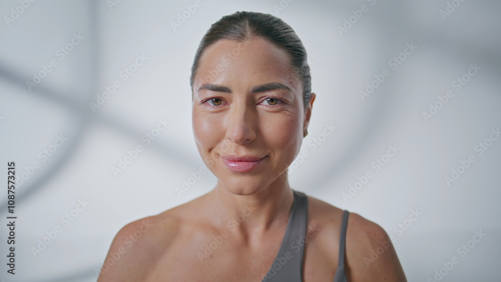 Obraz premium Portrait female yogi posing camera white wall background. Woman posing closeup