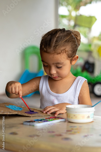 Obraz na płótnie A child participates enthusiastically in an engaging and creative painting activ