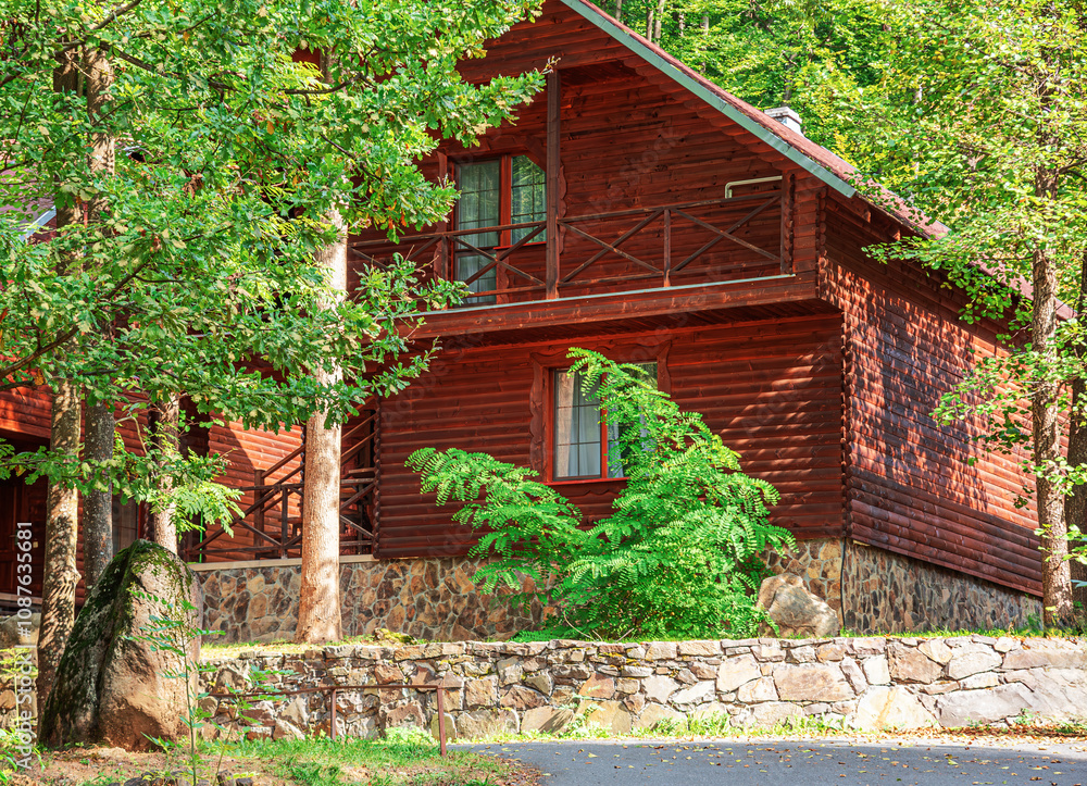 Wooden house in green forest in summer day. Wooden house in green forest in summer day.