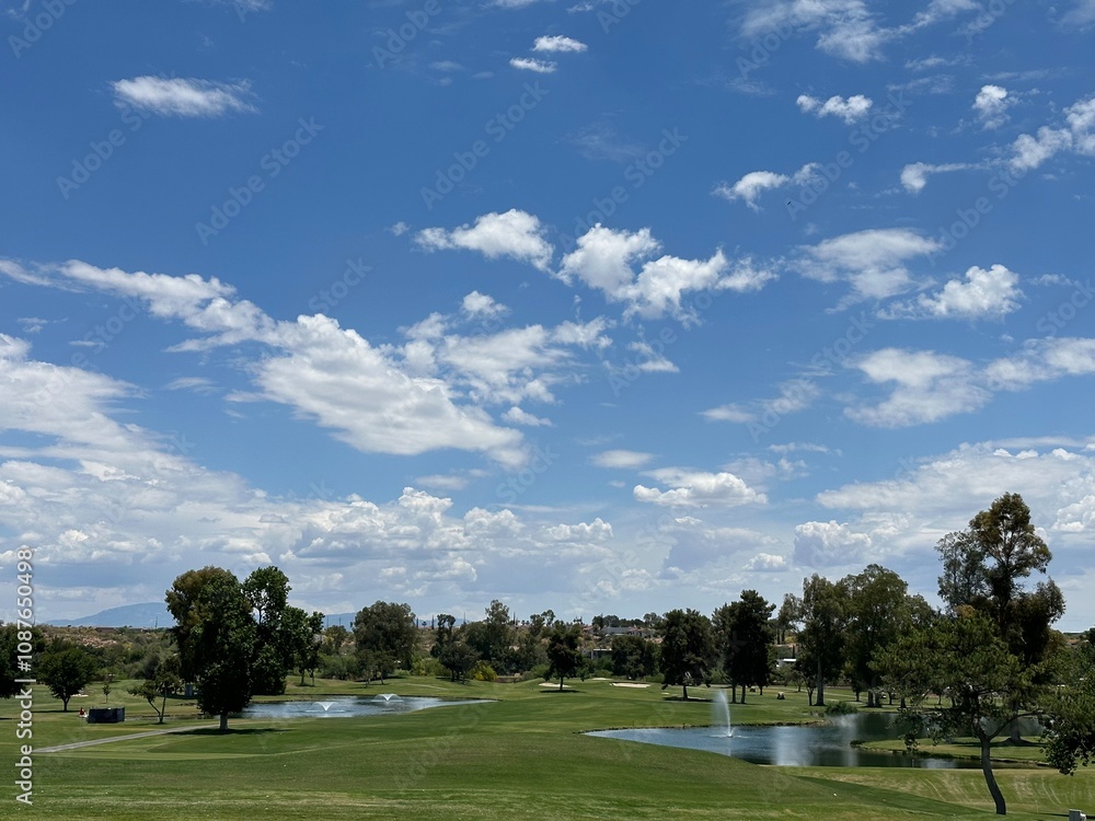 Scenic Golf Course in Arizona with Ponds and Trees Under a Blue Sky Scenic Golf Course in Arizona with Ponds and Trees Under a Blue Sky