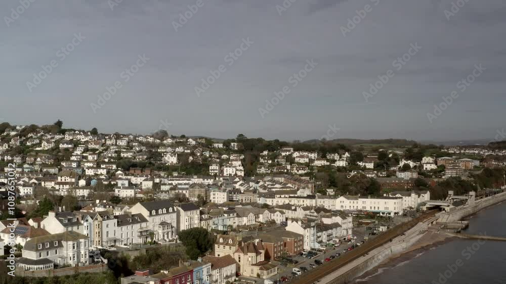 Aerial view of Dawlish a south coast seaside town taken from drone. Pretty seaside town in Devon with train travel along the shoreline UK 4K Aerial view of Dawlish a south coast seaside town taken from drone. Pretty seaside town in Devon with train travel along the shoreline UK 4K