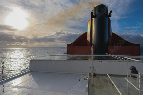 Breathtaking sunset sunrise ocean view from outdoor teak pool promenade deck of ocean liner at sea during transatlantic crossing to New York