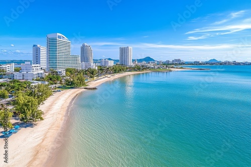 Aerial shot of a sprawling metropolitan area by the ocean, with high-rise buildings along the coastline photo