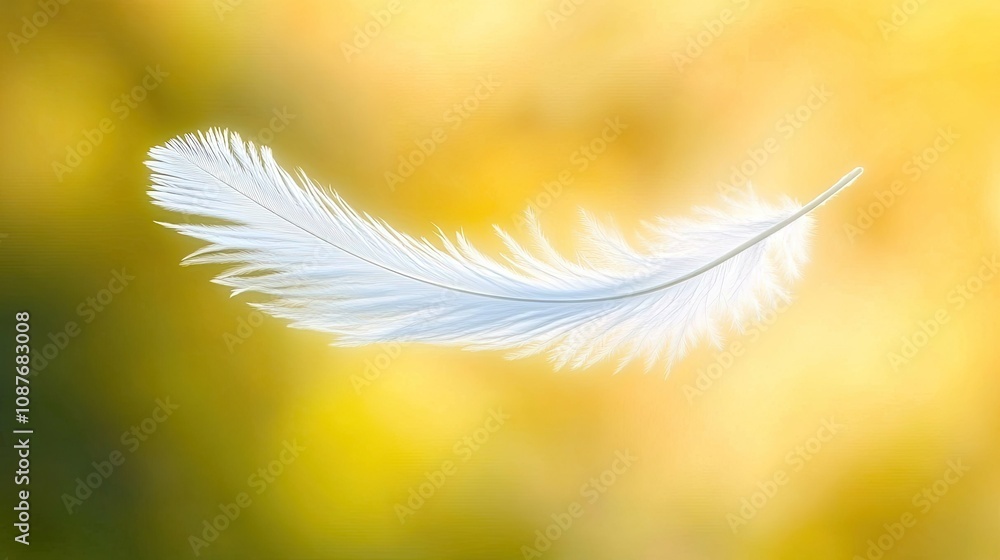 Naklejka premium Soft white feather floating mid-air, captured in motion, with a blurred background to emphasize its lightness and delicacy.