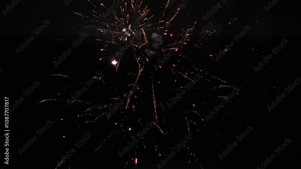 Firework display in the dark sky as beautiful colours light up a celebration. New year and 4th July party background 4K Firework display in the dark sky as beautiful colours light up a celebration. New year and 4th July party background 4K