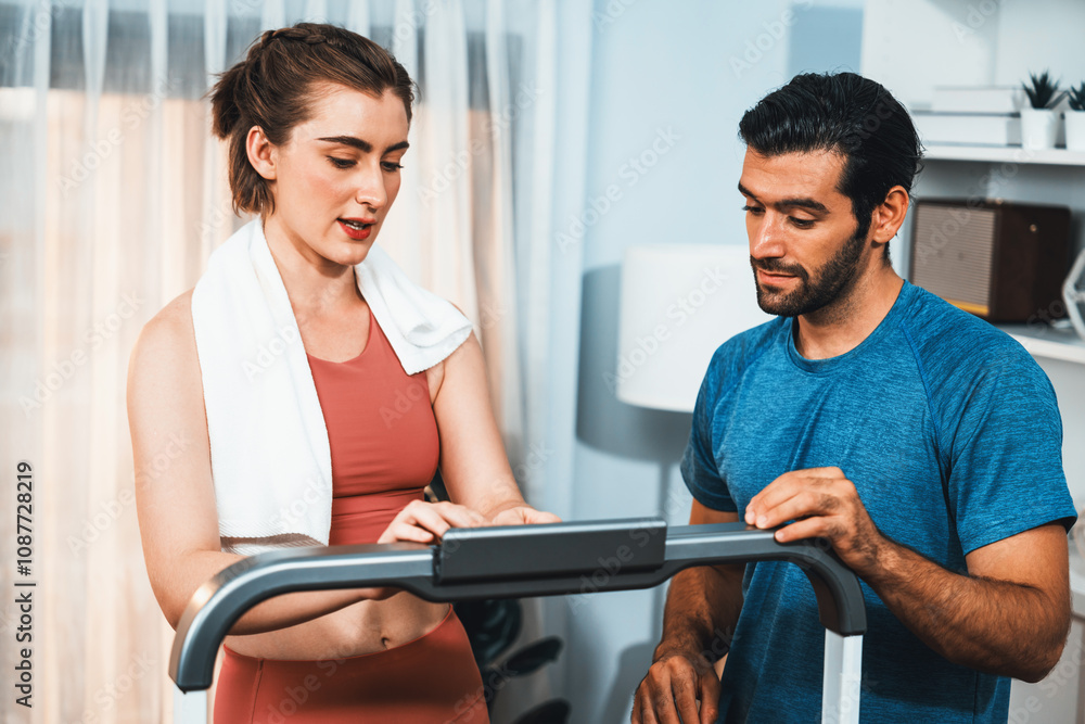 Athletic body and sporty young couple or workout buddy in sportswear warmup or resting after finishing in home workout exercise at gaiety home exercise and healthy lifestyle concept. Athletic body and sporty young couple or workout buddy in sportswear warmup or resting after finishing in home workout exercise at gaiety home exercise and healthy lifestyle concept.