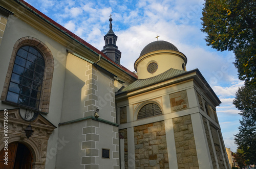 Cathedral of the Nativity of the Blessed Virgin Mary in Żywiec – a temple built in the fifteenth century with a high tower with a clock on it photo