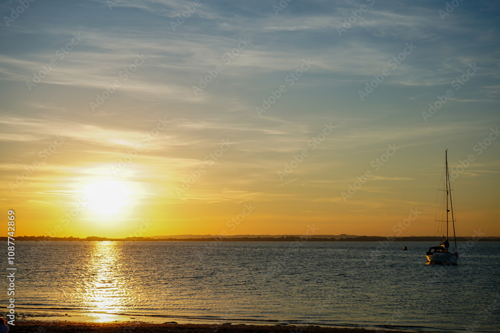 Setting sun over a sandy beach in the South of England        