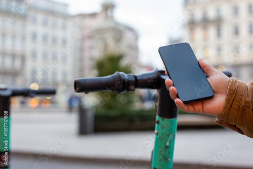 Tourist using smartphone app to rent electric scooter in city center