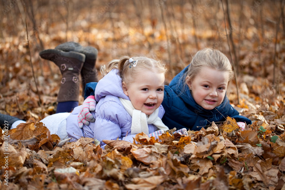 Two sisters in autumn park Two sisters in autumn park