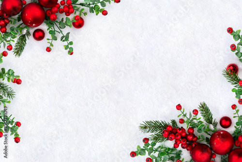 Christmas decoration. Red christmas balls, red berries, branches christmas tree on snow with space for text. Top view, flat lay