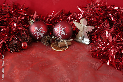 christmas decoration on red. red New Year's balls with snowflakes, cones, an angel in a New Year's card.