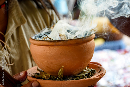 Aromatic herbs burning from a clay pot at the Umbanda smoking ceremony in Brazil photo