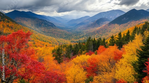 Autumn glory in New England. Stunning view of forest, mountains, and vibrant fall foliage from top of Kinsman Notch in the White Mountains of New Hampshire