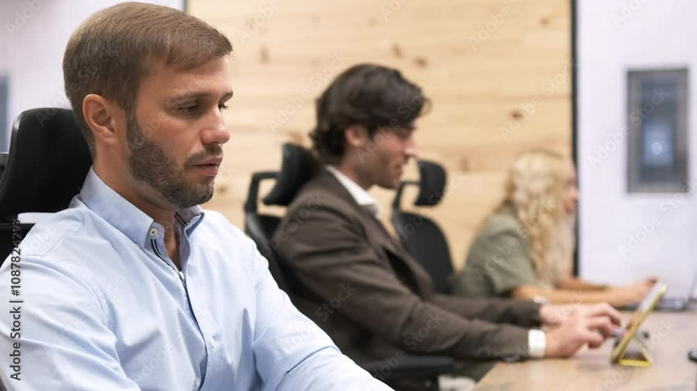 Businessmen talking while working in modern office Businessmen talking while working in modern office