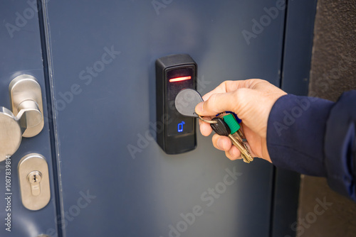 Tableau sur toile Close up view of person using a electric lock key fob to access a building via a
