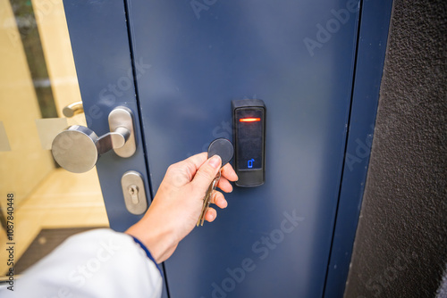 Foto Close up view of person using a electric lock key fob to access a building via a