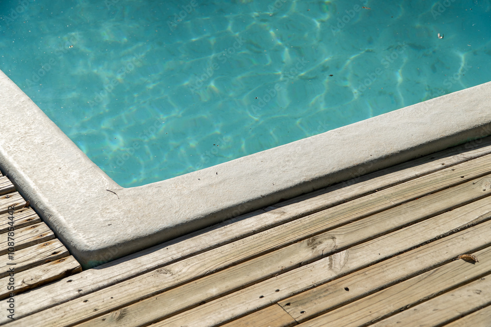close-up of a pool with shimmering water, reflecting sunlight.