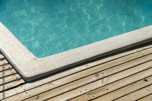 close-up of a pool with shimmering water, reflecting sunlight.