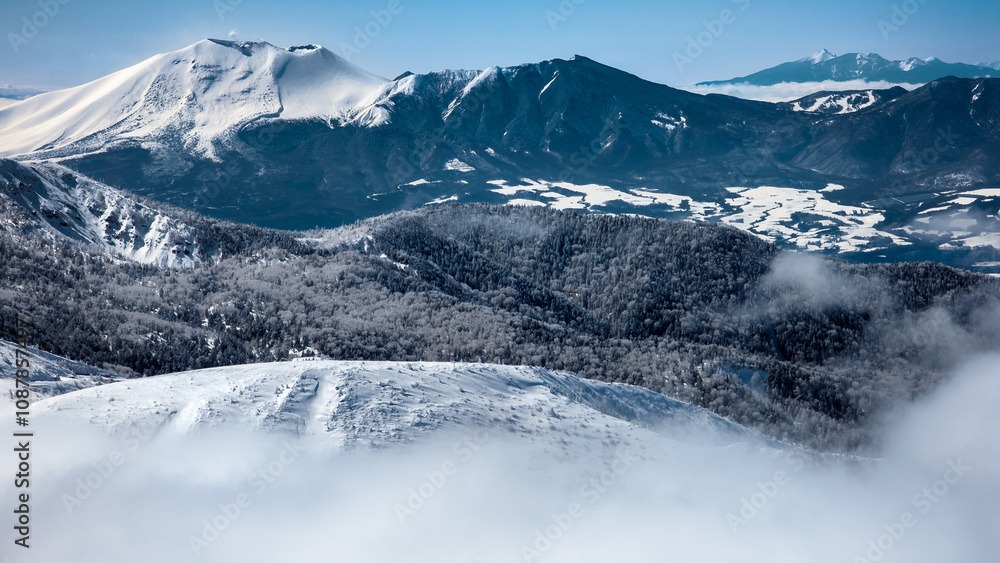 Obraz premium Steaming stratovolcano on a snowy landscape (Mount Asama, Japan)