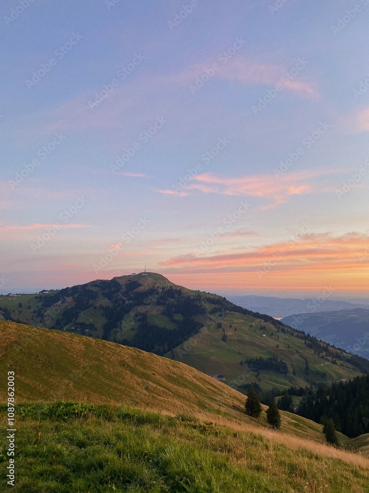 Fototapeta premium Rolling Hills and Vibrant Sunset in the Swiss Countryside