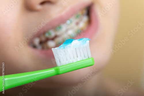 A 10-year-old teenager in dental braces is brushing his teeth. the concept of healthy teeth and proper dental care