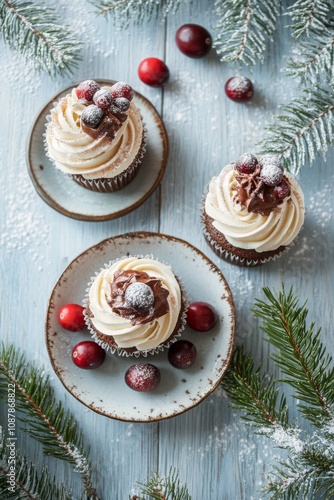 Delicious chocolate cupcakes topped with cream and cranberries on a festive t...